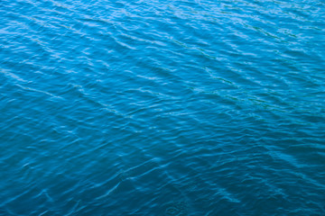 Clear blue sea water surface in sunny day.