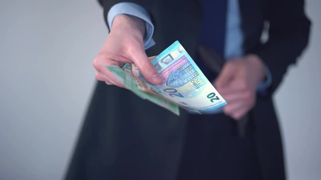 Man proposing bundle of euros, purchase in shop, payment of penalty, kickback