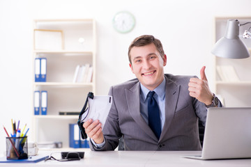 Businessman with virtual reality glasses in office