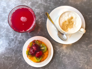 Cake, cappuccino and juice for lunch