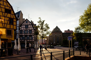 Gorgeous cobbled street in Colmar, Alsace, with many bars and businesses during sunset