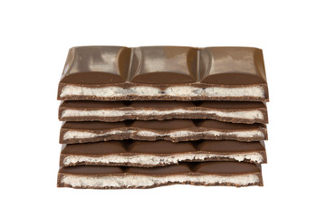 Stack of milk chocolate bar slices isolated on white background.