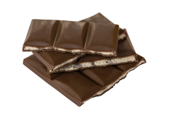 Tasty milk chocolate bar slices isolated on white background.