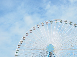 ferris wheel against the blue sky