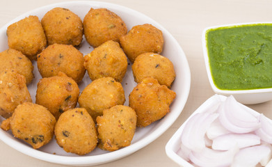 Indian Spicy Street Food Dal Vada Also Know as Moong Dal Vada, Pakoda, Pakode, Pakore, Moong Vada, Pakora or Bhajiya Served with Green Chutney or Onion