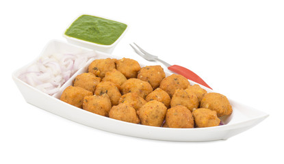 Indian Spicy Street Food Dal Vada Also Know as Moong Dal Vada, Pakoda, Pakode, Pakore, Moong Vada, Pakora or Bhajiya Served with Green Chutney or Onion isolated on White Background