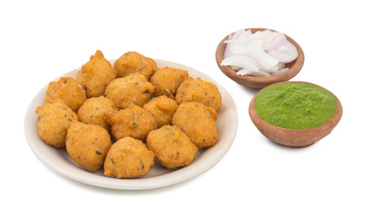 Indian Spicy Street Food Dal Vada Also Know as Moong Dal Vada, Pakoda, Pakode, Pakore, Moong Vada, Pakora or Bhajiya Served with Green Chutney or Onion isolated on White Background