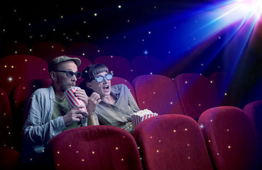 Fototapeta na wymiar Lovely couple watching 3D movie with little sparkling stars around