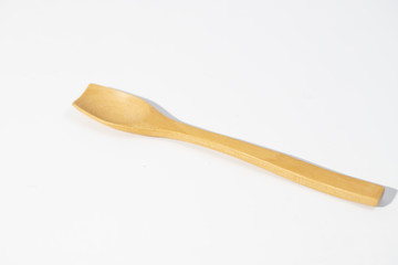 little brown wood spoon in white background