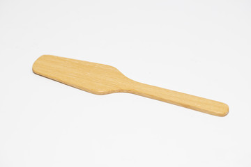 little brown wood spoon in white background