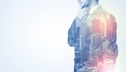 Businessman in suit standing thinking with metropolis graphic 