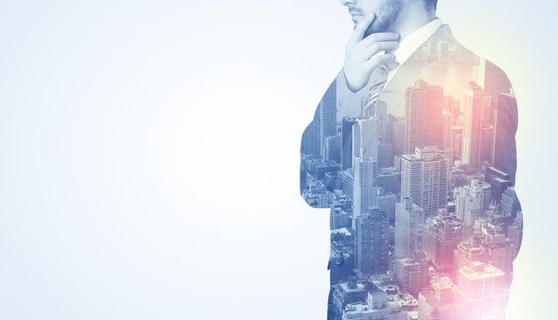 Businessman in suit standing thinking with metropolis graphic 