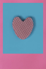 Creative heart from an edible wafer in pastel pink and blue colors. Abstraction. Template.