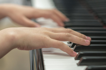 Fototapeta premium children's hands are playing the piano. Child's hand on piano keys.