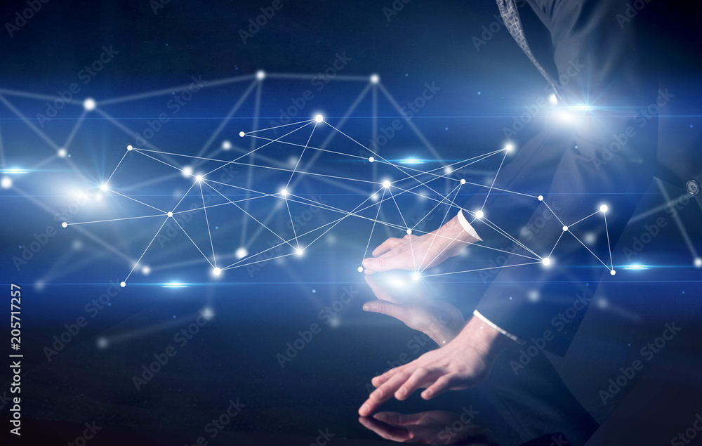 Poster male hands touching interactive table with blue connectivity graphic in the background