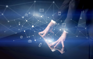 Male hands touching interactive table with blue mixed communication icons in the background