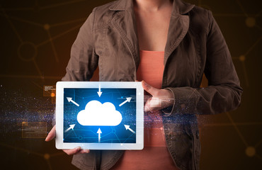 Casual young woman holding tablet with cloud concept