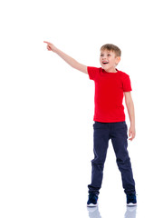 The boy points a finger at something.