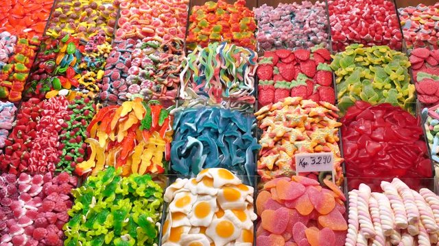Assorted colorful jelly candies on display at La Boqueria market, Barcelona