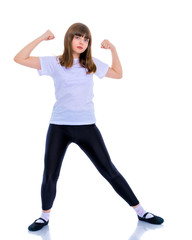 A little girl shows her muscles.