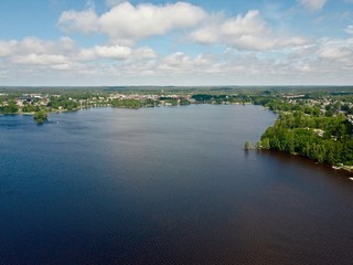 Fototapeta na wymiar Drone view of a big lake in Sweden with a city on the background, Summer in Sweden