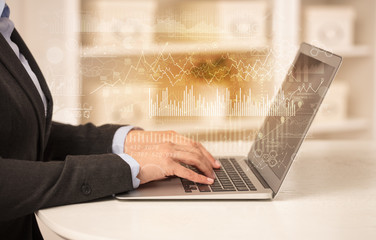 Business woman in homey environment using laptop with global financial report concept
