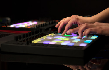 Fototapeta premium Dj hand remixing music on midi controller 