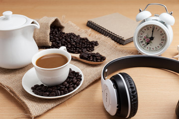 Obraz na płótnie Canvas coffee cup and headphone on wood plank background.