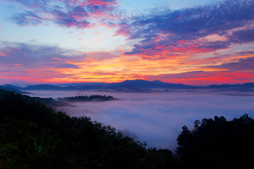 Fototapeta na wymiar Beautiful sunrise or sunset with fog flowing in the mountain beautiful landscape scenery view in thailand.