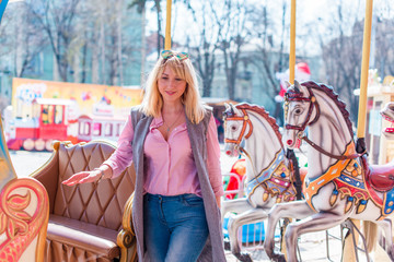 Nice beautiful fashionable woman in an amusement park. Pretty , middle age lady having fun at an...