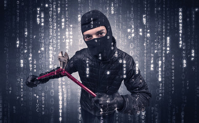 Burglar in action with encoded concept and his tools in his hand. 