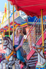 Nice beautiful fashionable woman in an amusement park. Pretty , middle age lady having fun at an amusement park. Joy in adult life 