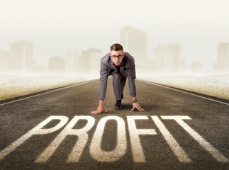 Young determined businessman kneeling before profit sign