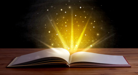 Yellow lights and sparkles coming from an open book 