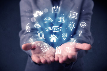 Blue multimedia icons in the hands of a businessman