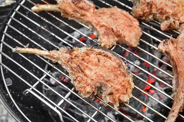 Cooking of appetizing juicy spare ribs outdoors