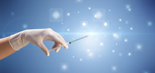 Female doctor hand holding syringe with shiny crosses in the background