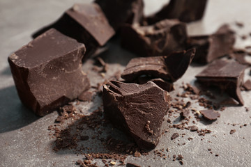 Delicious dark chocolate on grey background, closeup