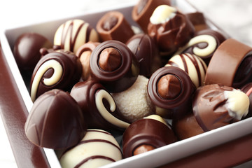 Different tasty chocolate candies, closeup
