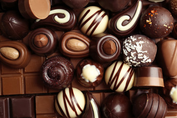 Many different tasty chocolate candies as background