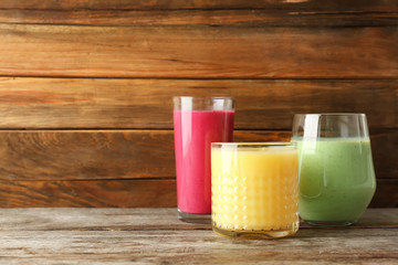 Glasses with delicious detox smoothies on table