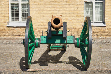 An old bronze cannon on a wooden carriage. It is located in the fortification building of the...