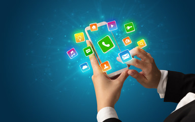 Female hand using smartphone with 3D shiny starlike application icons around
