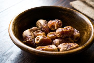 Dried date palm fruits or kurma, ramadan ( ramazan ) Medjool food in wooden bowl.