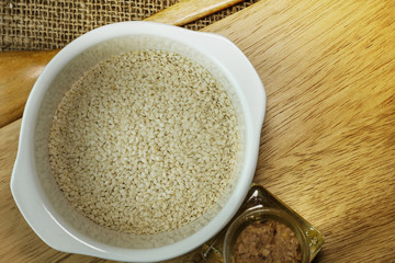  white Sesame seeds  on a old wooden table..