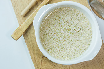  white Sesame seeds  on a old wooden table..