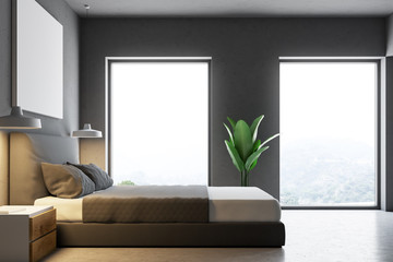 Side view of a gray bedroom with a poster