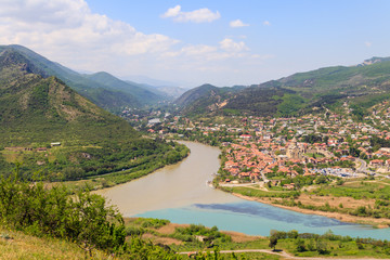 Naklejka na ściany i meble Aerial view on old town Mtskheta and confluence of the rivers Kura and Aragvi in Georgia