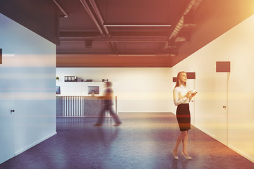 Black office corridor, wooden reception toned