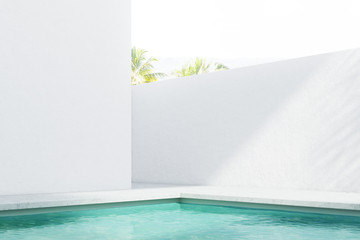 Fototapeta na wymiar Resort pool near a white wall, side view
